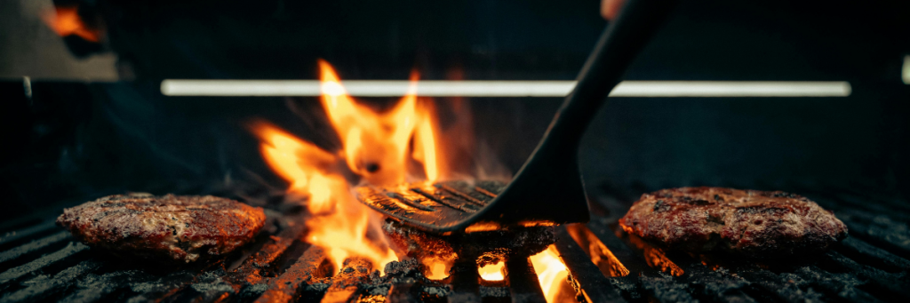 Burger pressed on grill